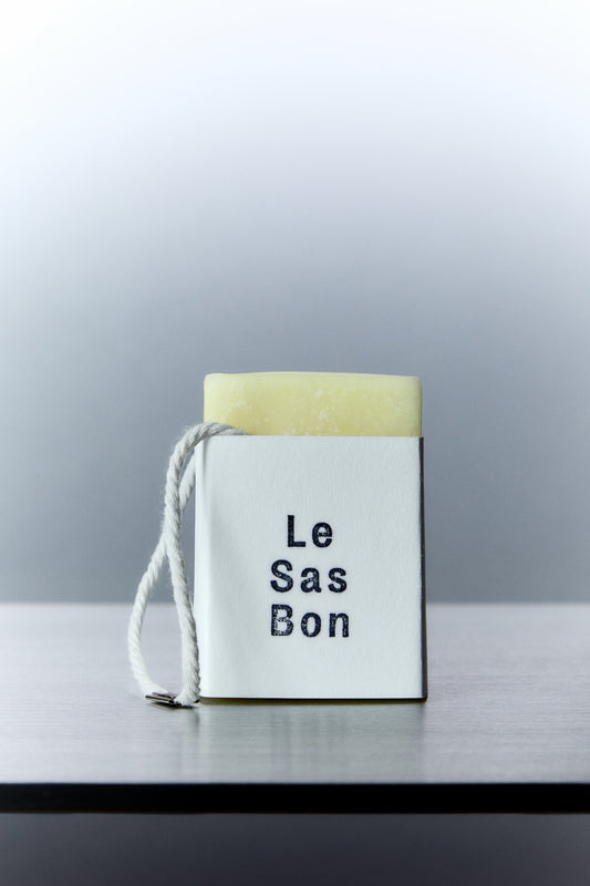 Cube of scented wax melt in Le Sas Bon branded sleeve with rope dangling outside
