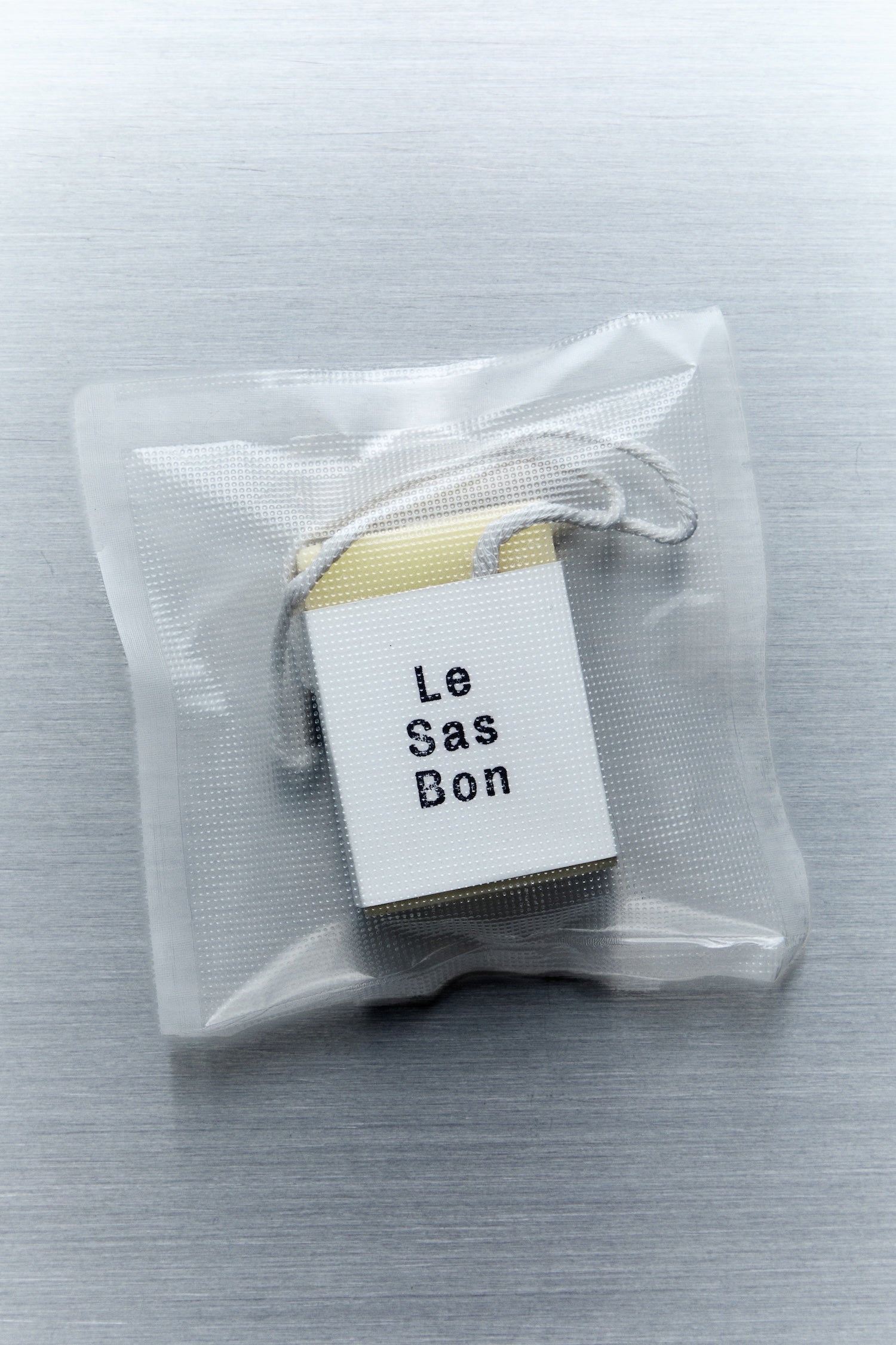 Scented cube wax melt and Le Sas Bon branded sleeve inside a clear rectangular plastic bag