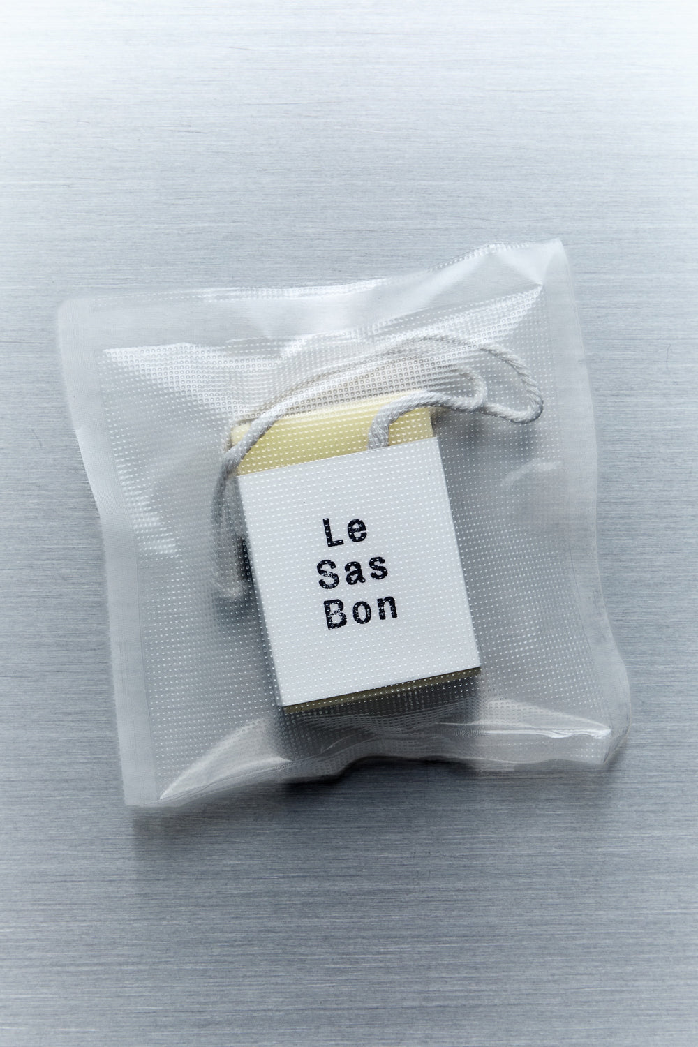 Scented cube wax melt and Le Sas Bon branded sleeve inside a clear rectangular plastic bag