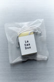 Scented cube wax melt and Le Sas Bon branded sleeve inside a clear rectangular plastic bag