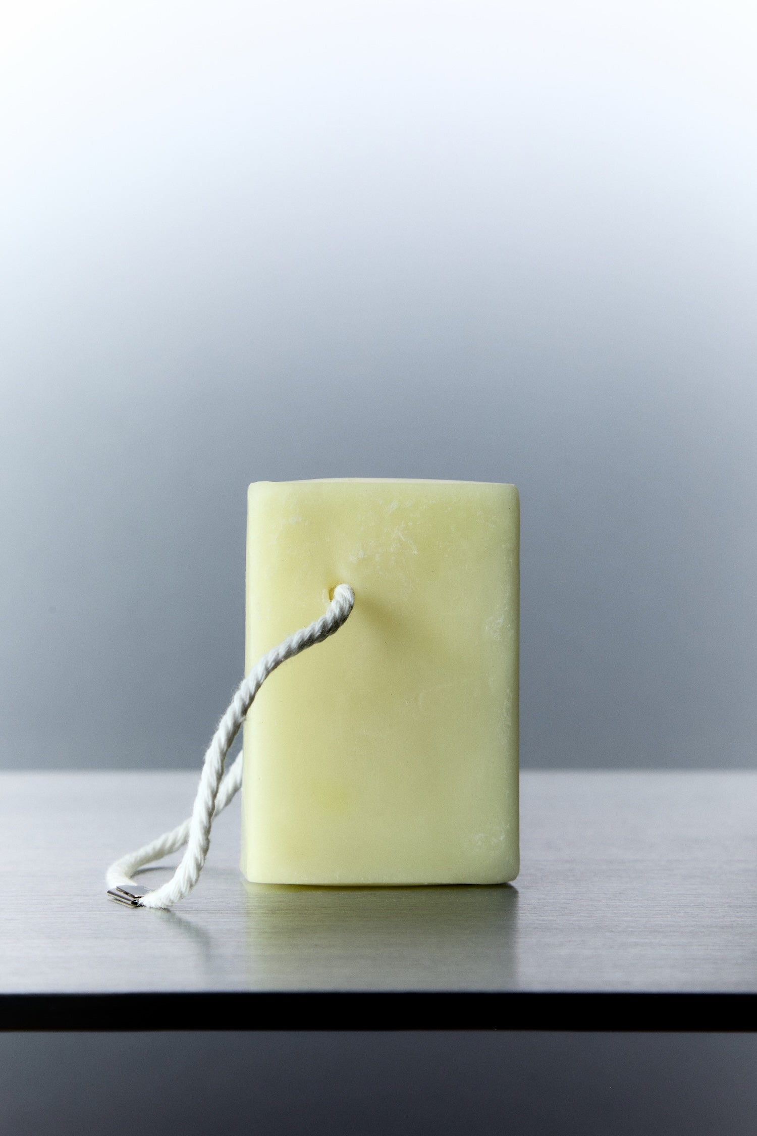 Scented wax melt cube plus rope handle on top of silver table